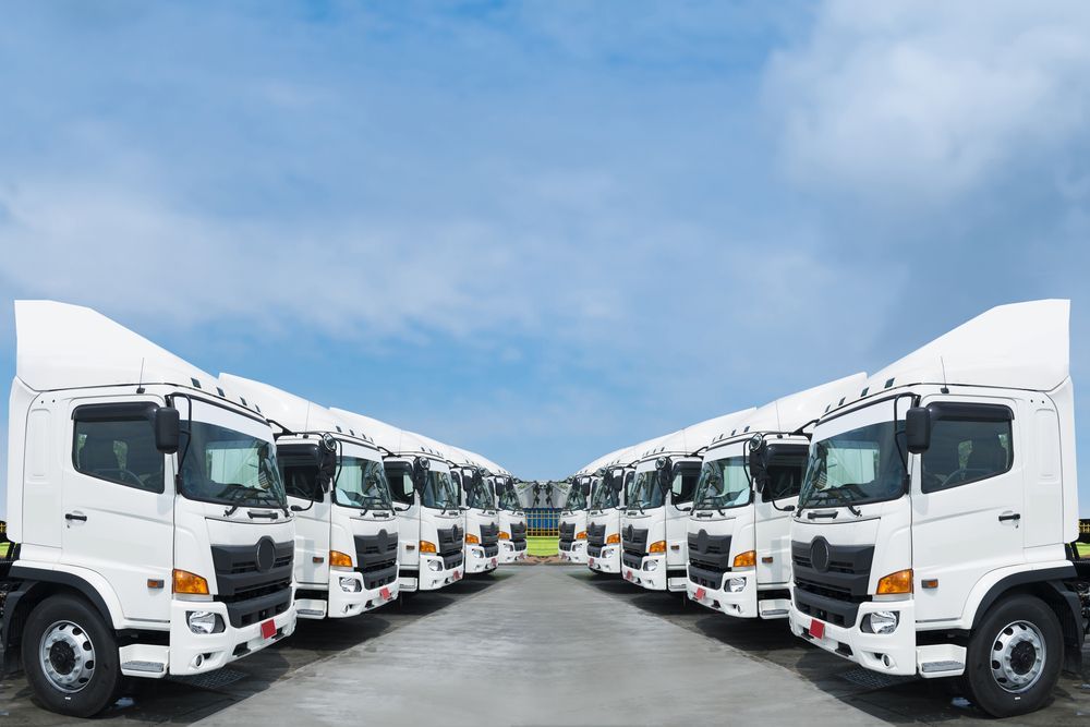 White semi-trucks parked in a line, under a blue sky with clouds — Full Noise Mechanical in Humpty Doo, NT