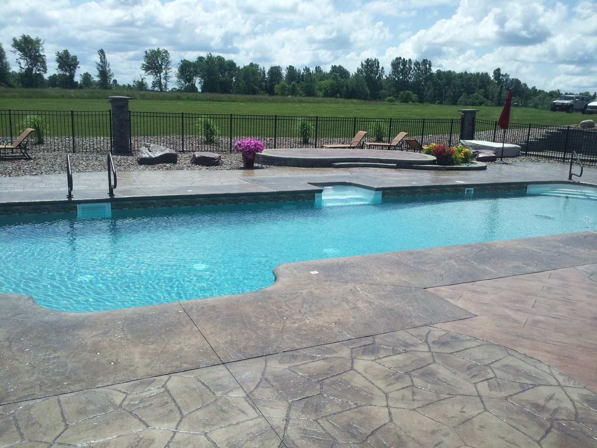A large swimming pool with a fence around it