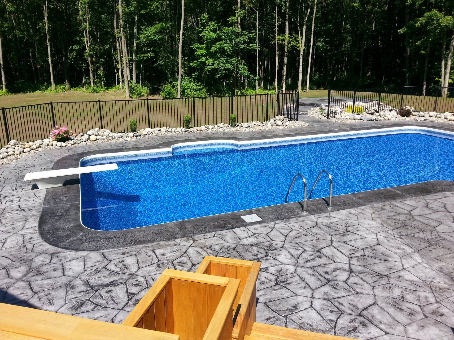 A large swimming pool with a diving board in the middle