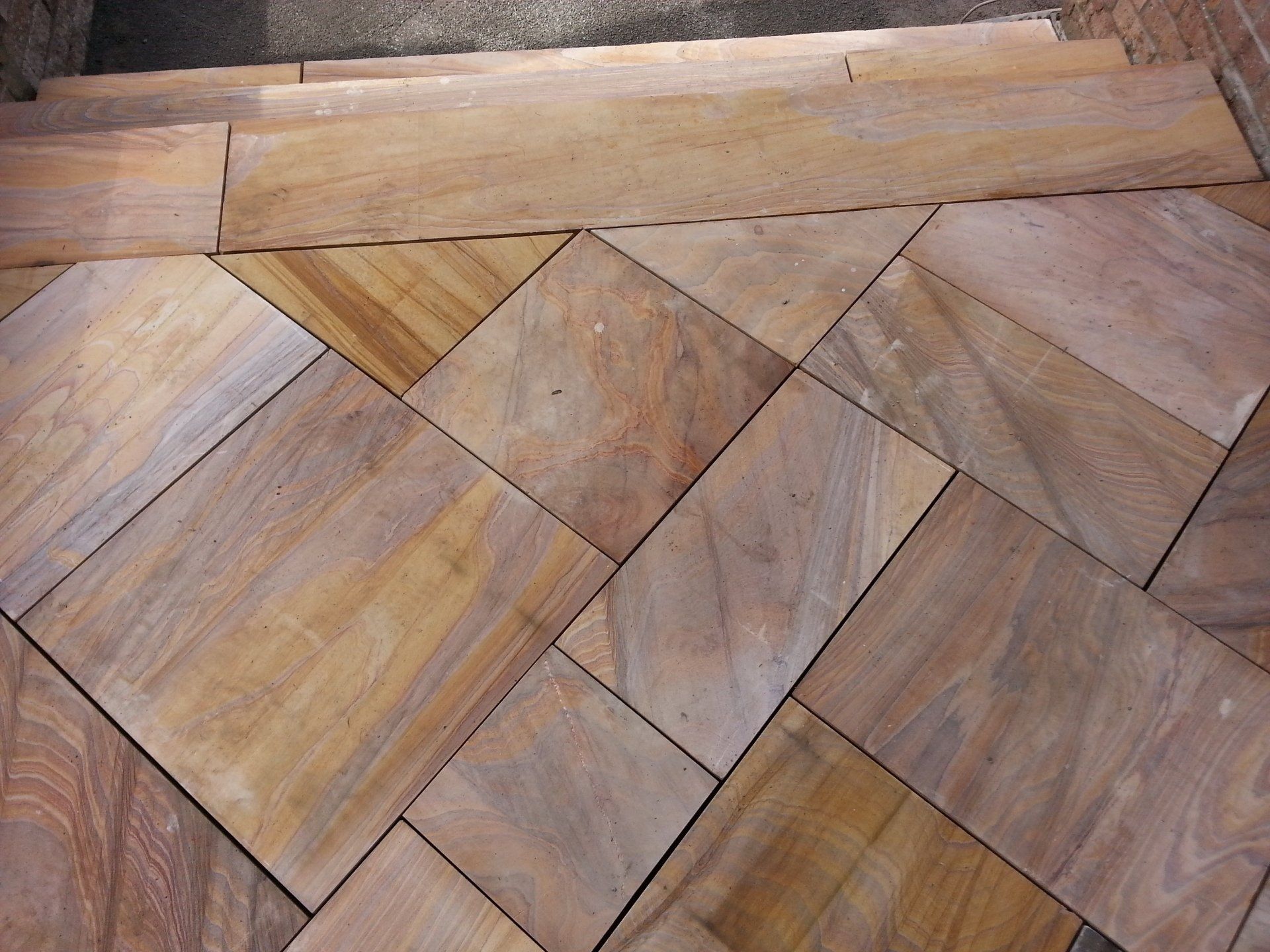 A close up of a wooden floor with a diagonal pattern