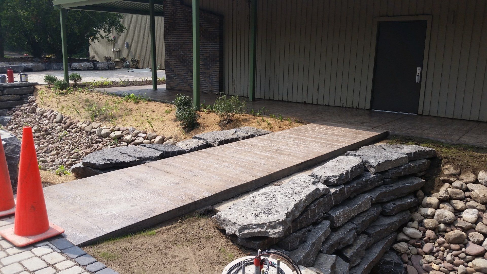 A concrete walkway is being built in front of a building.