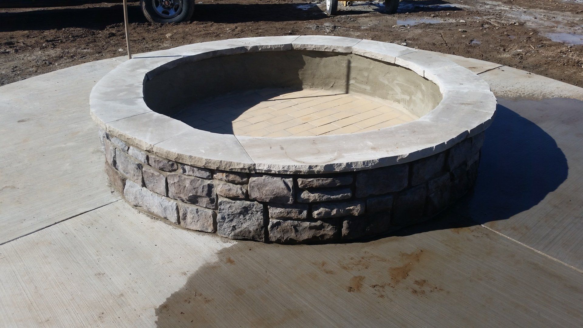 A fire pit is sitting on a concrete surface