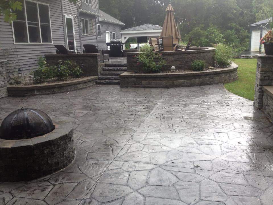 There is a fire pit in the middle of the patio.