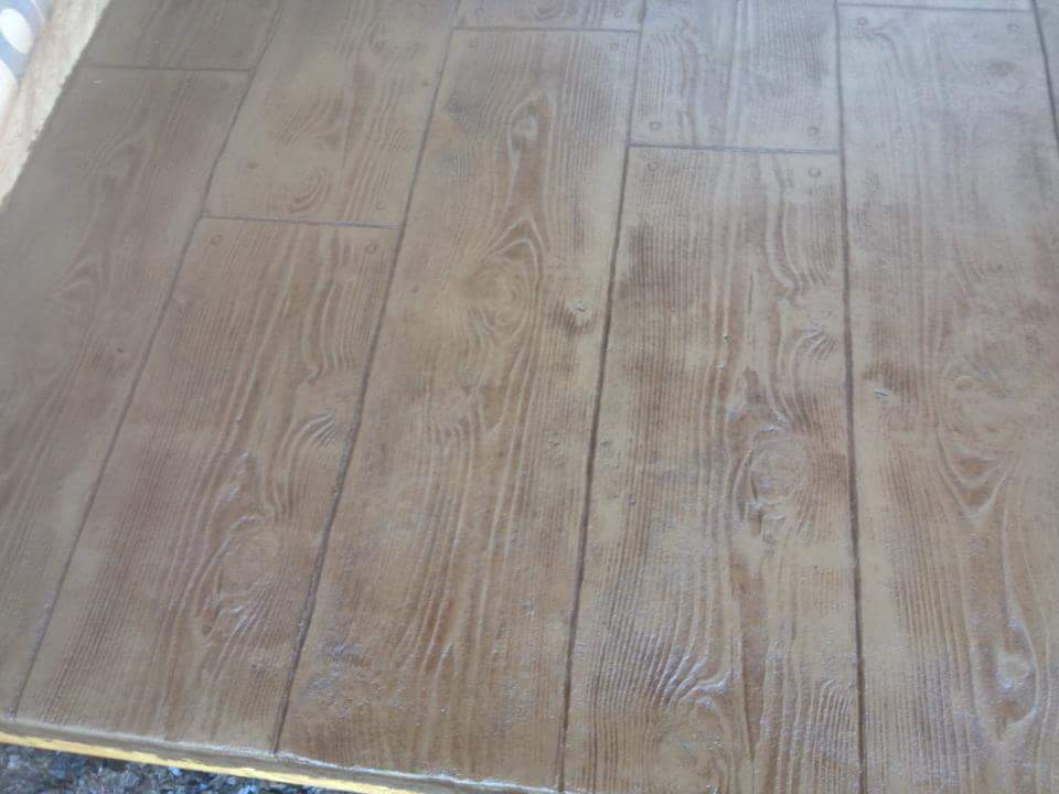A close up of a wooden floor with a yellow border