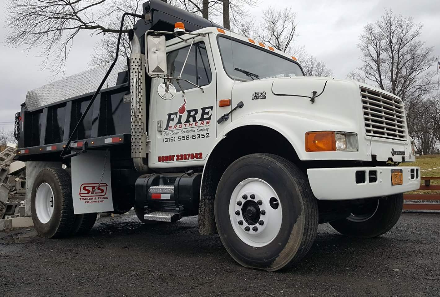 A white dump truck with the word fire on the side