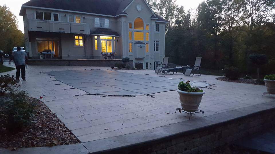 A large house with a swimming pool in front of it