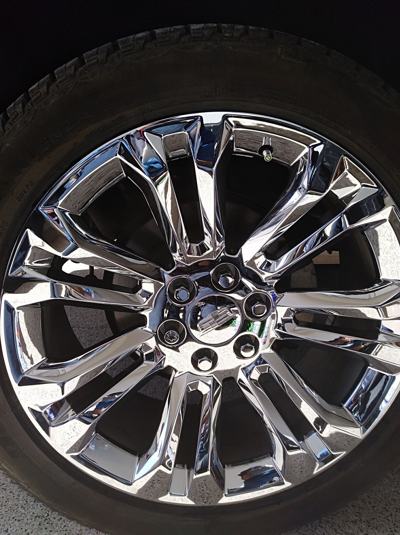 a close up of a chrome wheel on a car