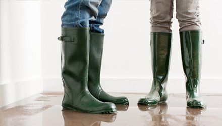 Two men wearing rubber boots