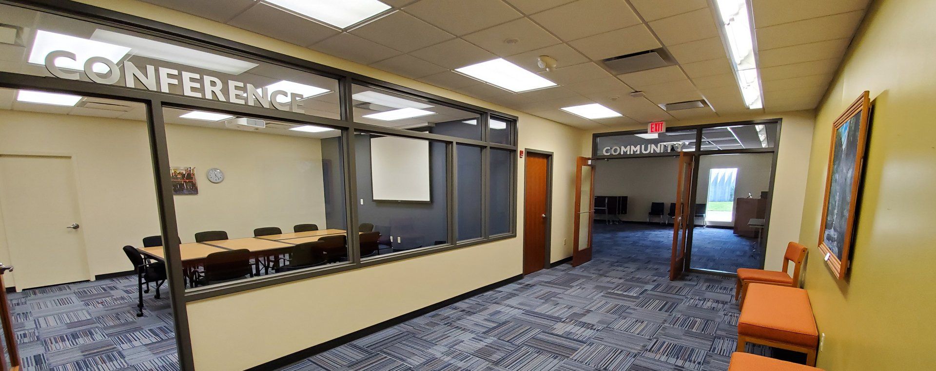 There is a conference room with a table and chairs in it.