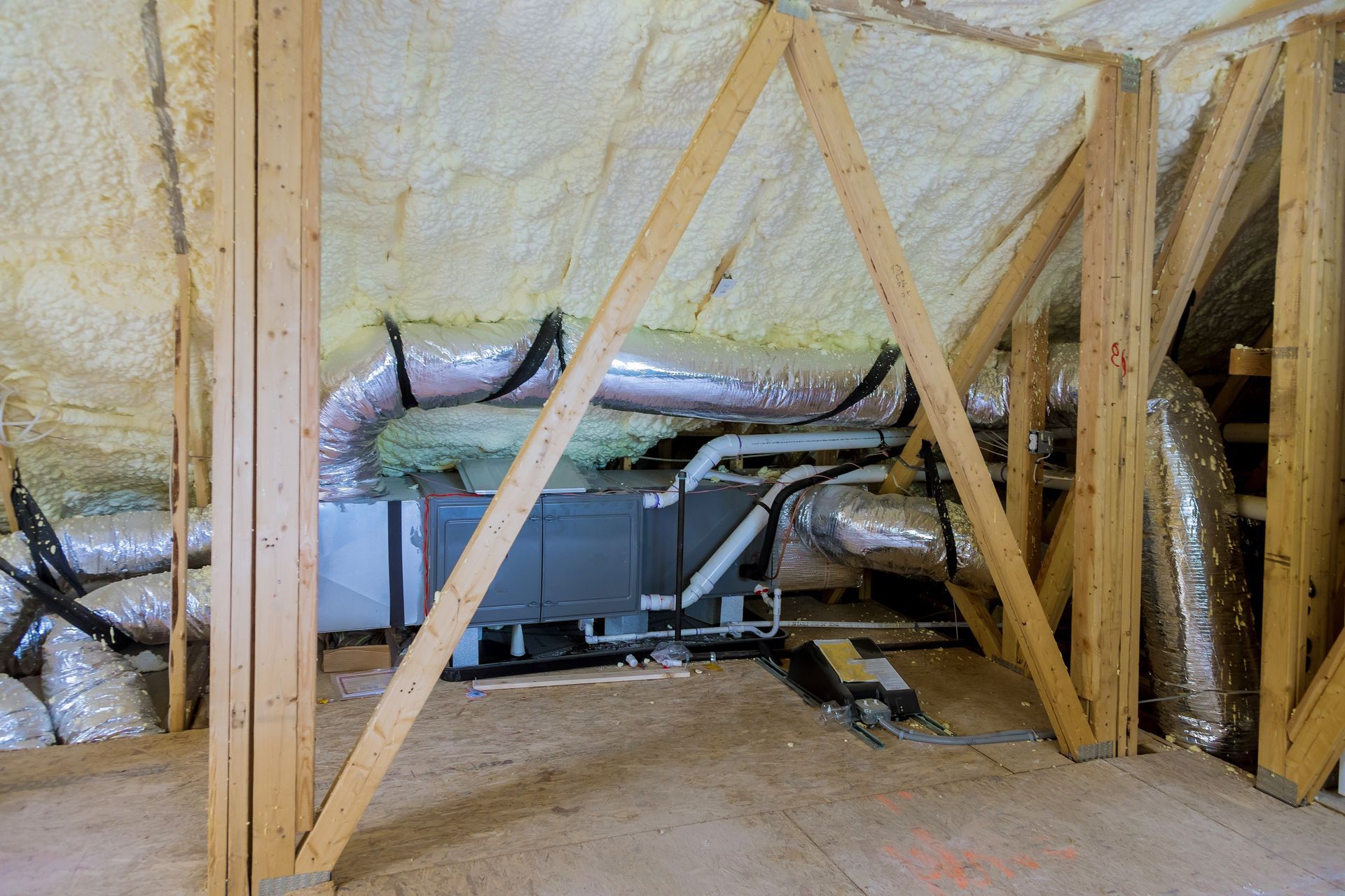 air conditioning system attached to attic surrounded by spray foam insulation