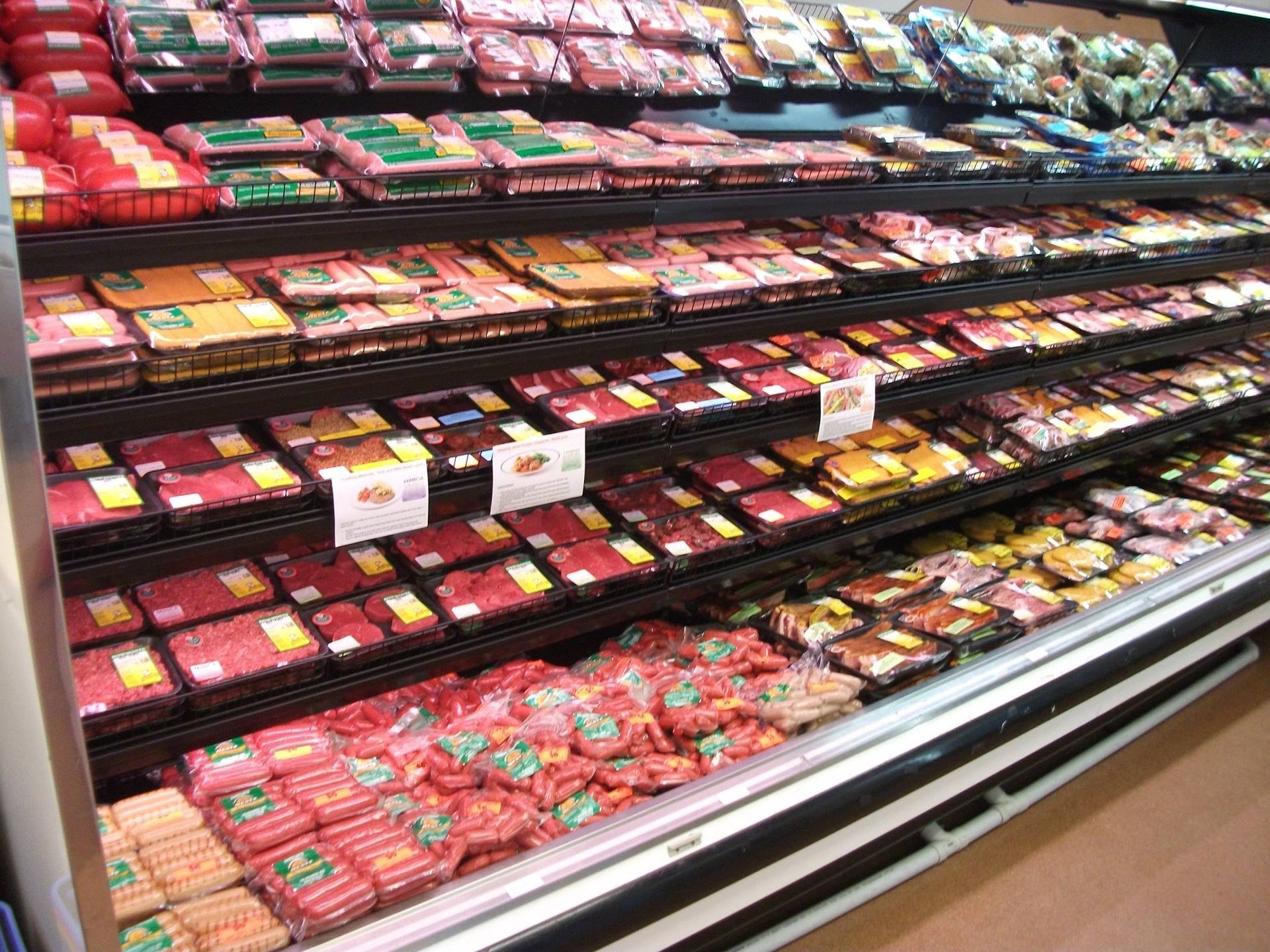 Meat products in a refrigerated grocery store display.