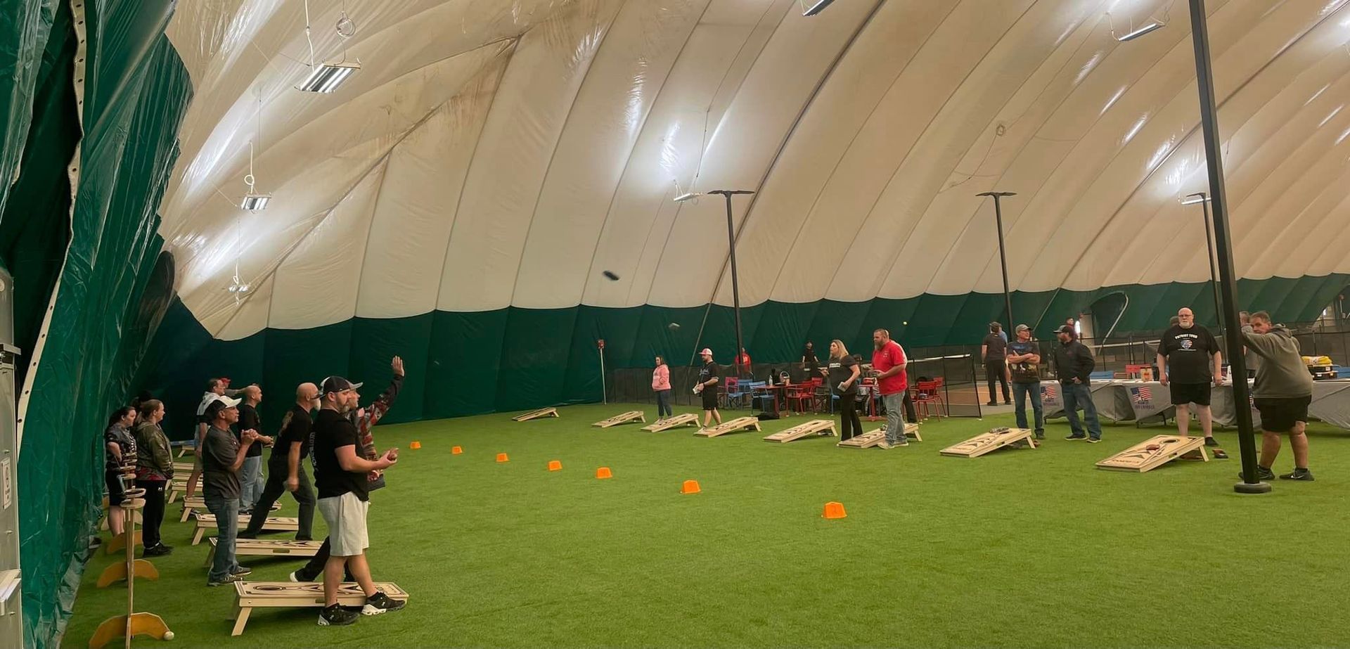 seven teams playing cornhole