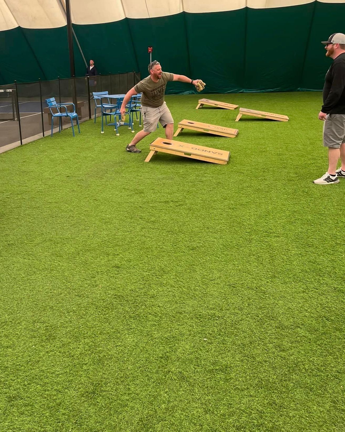 a man playing cornhole