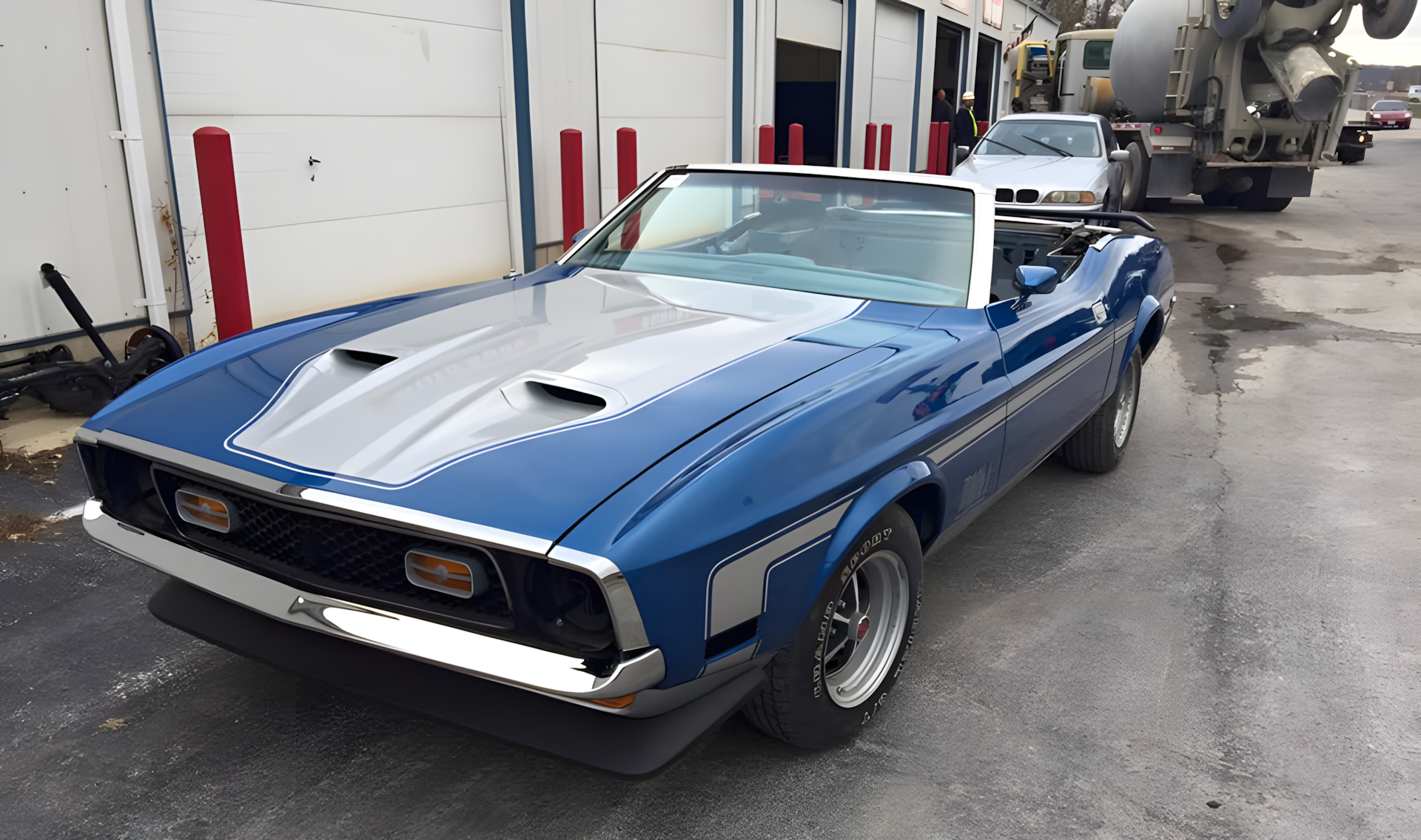 Blue convertible Ford Mustang with silver stripes, parked outside. | C & C Auto