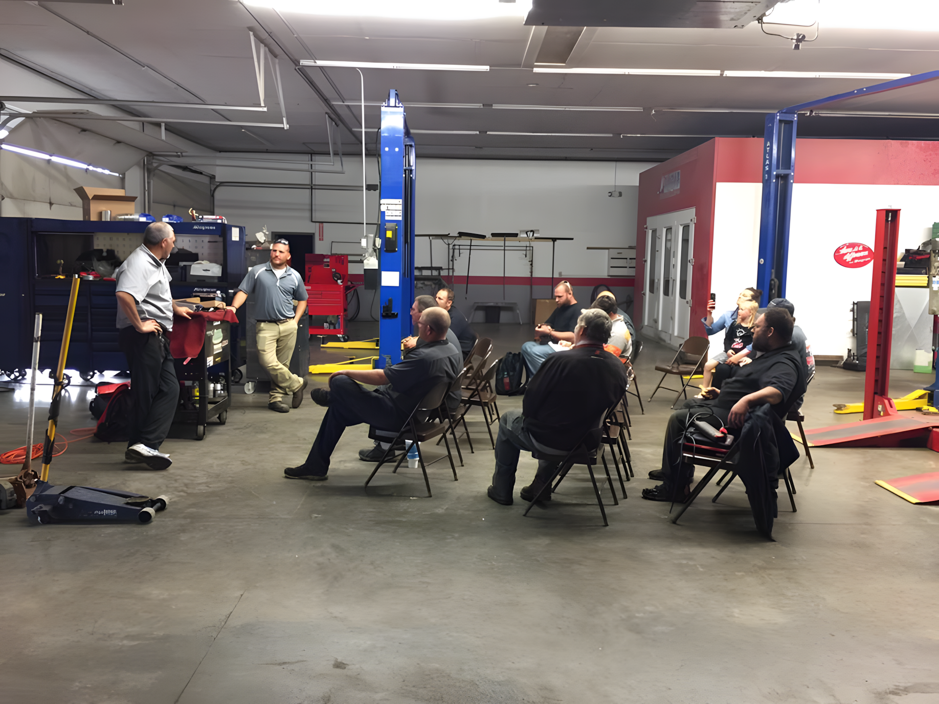 Men in an auto shop & some seated | C & C Auto