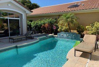 Sliding Doors — A House with Wide Windows Beside the Pool in Deerfield Beach, FL