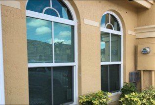 Window Installation — Yellow House with New Windows in Deerfield, FL