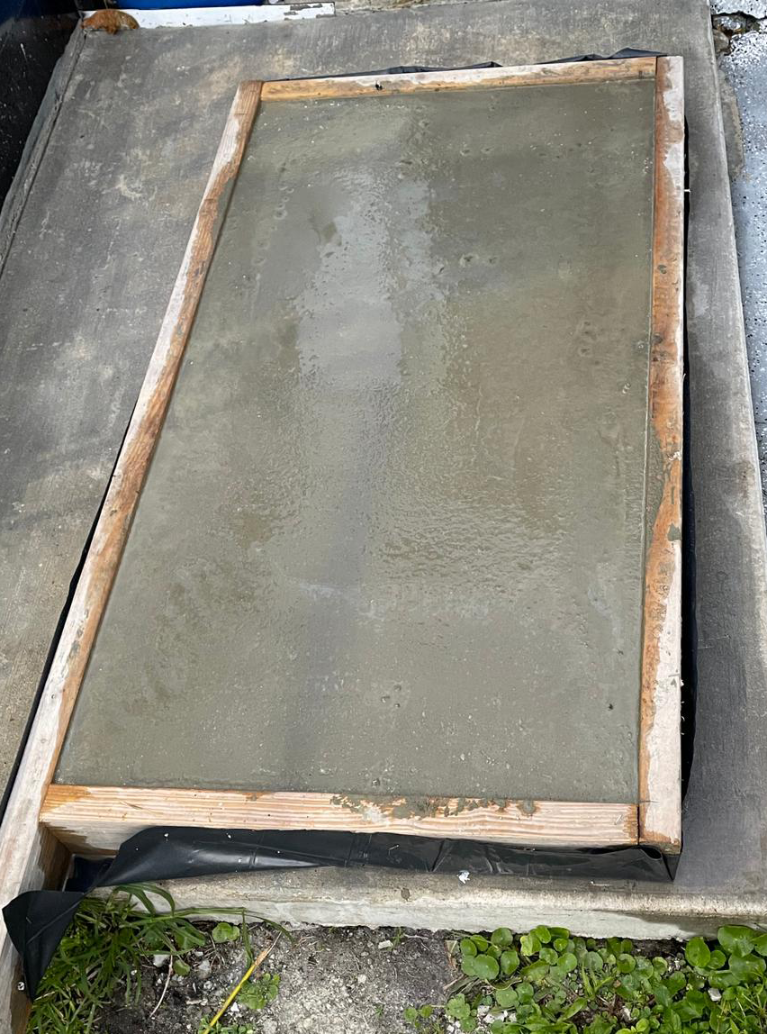 A wooden frame is sitting on top of a concrete slab.