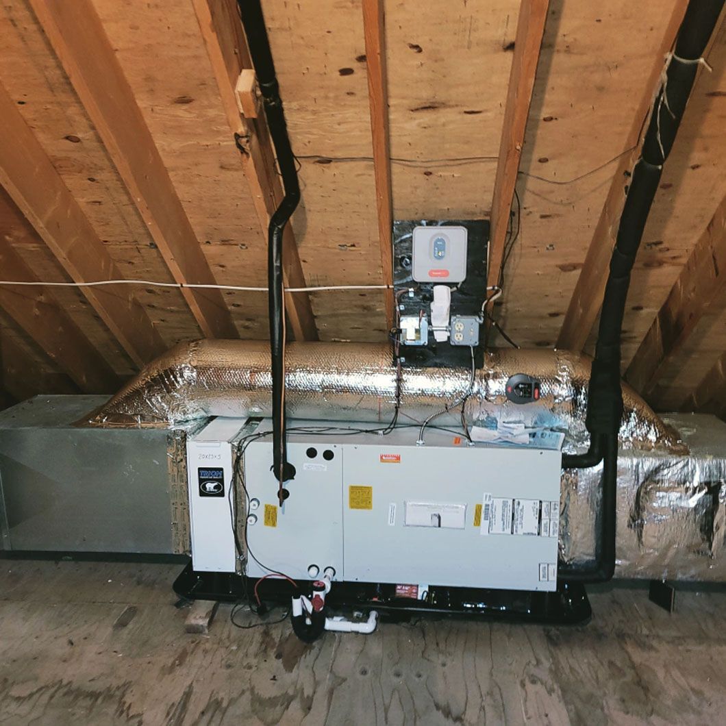 A large white box is sitting under a wooden ceiling in a room.