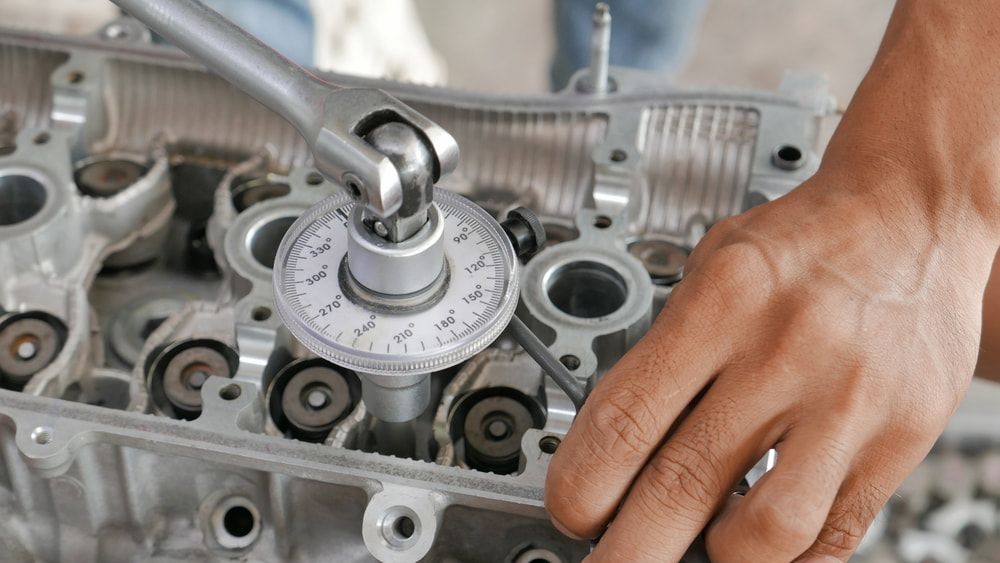 A Mechanic Uses a Torque Angle Gauge to Tighten a Bolt — JNL Crankshaft Services in Palmerston City, NT