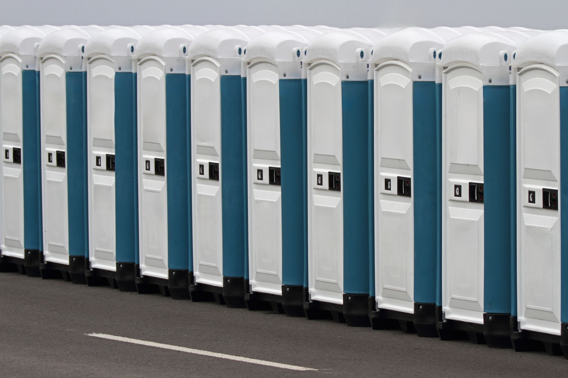 Many portable toilets at an event.