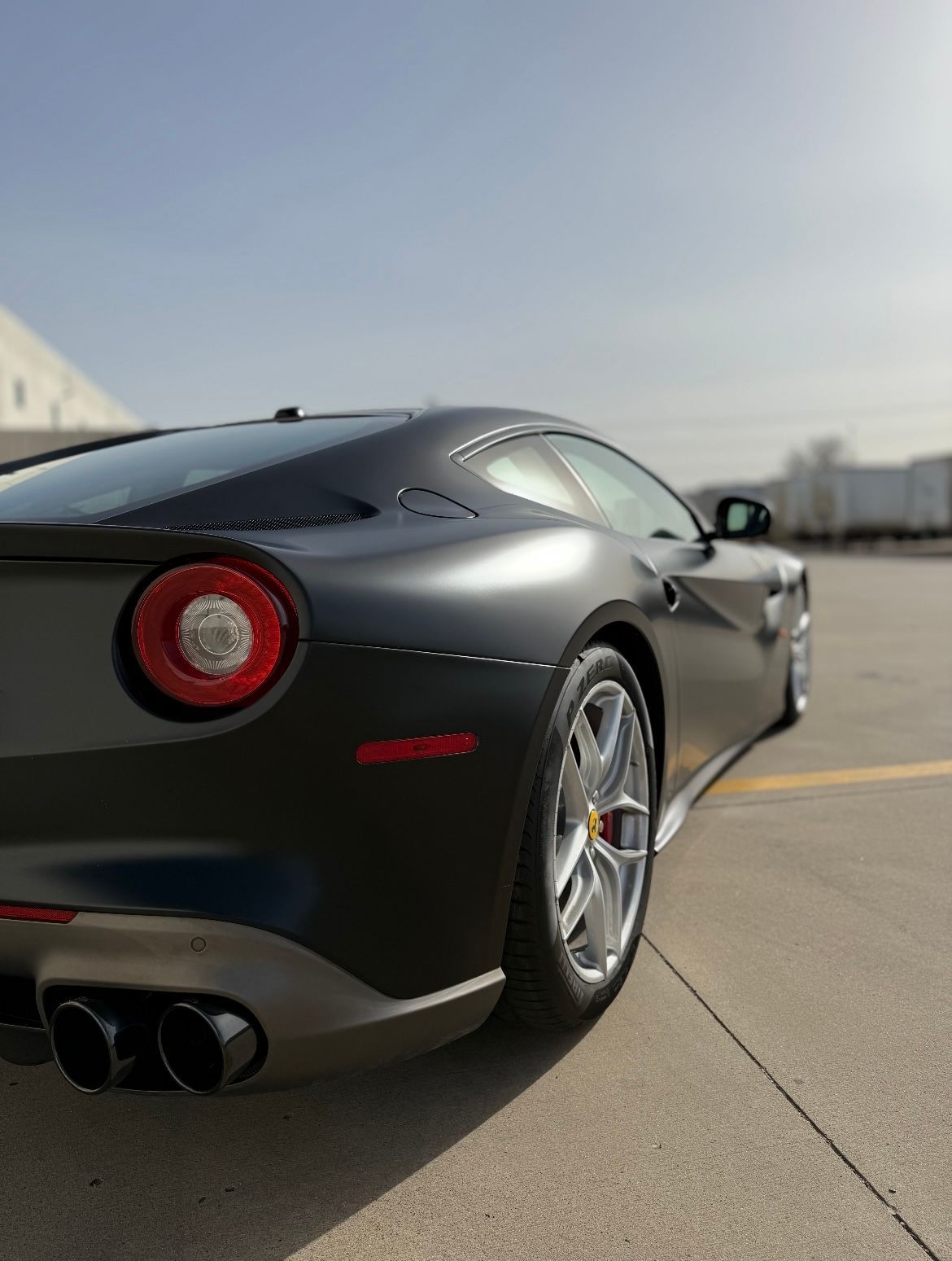 A black sports car is parked on the side of the road