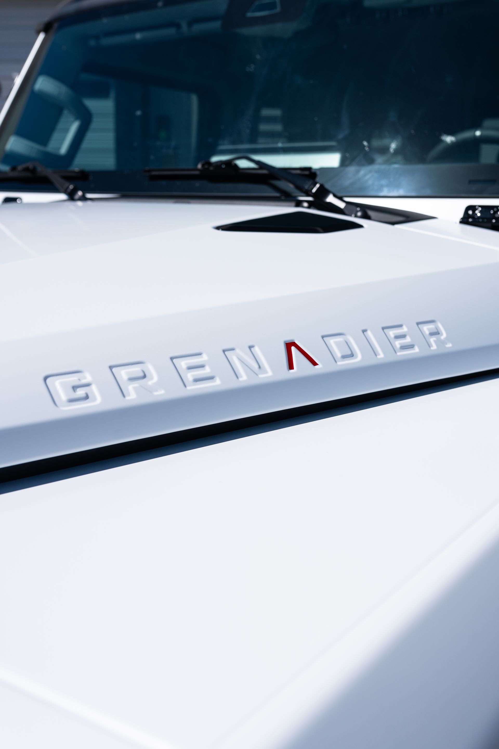 White vehicle hood with the word 