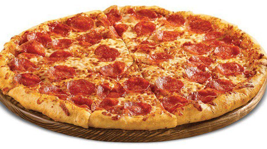 Pepperoni pizza on a wooden platter, sliced into wedges.