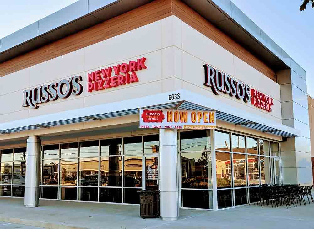 Exterior of Russo's New York Pizzeria restaurant with red signage. A 