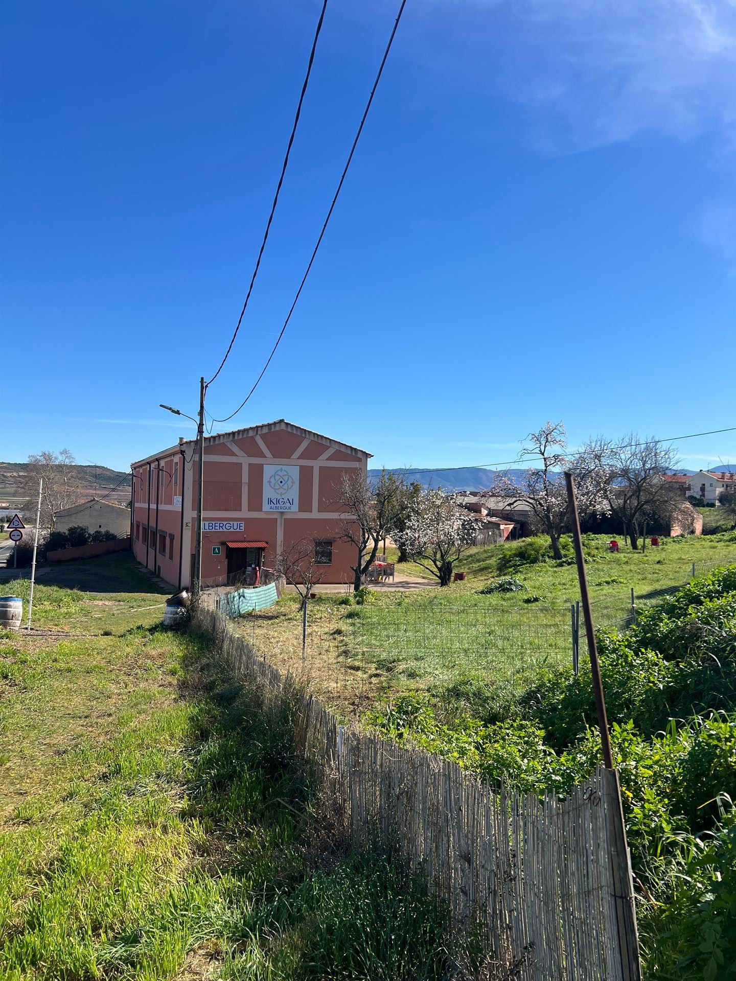 Un dormitorio con dos camas y una lámpara en la mesita de noche.