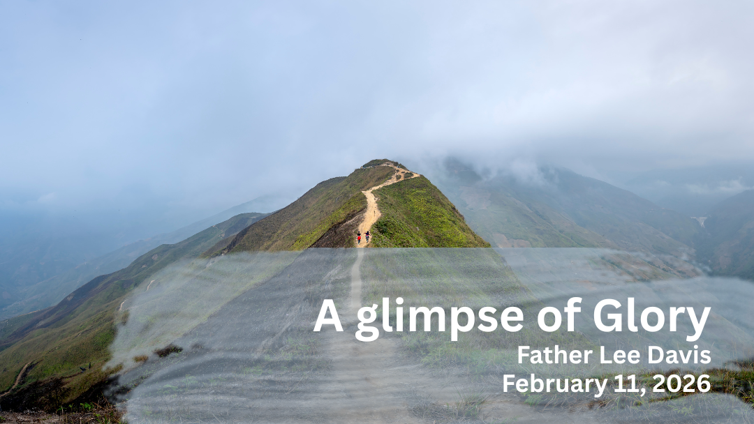 two people walking up a mountain  top.