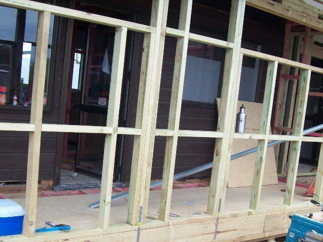 A blue cooler sits in front of a building under construction.