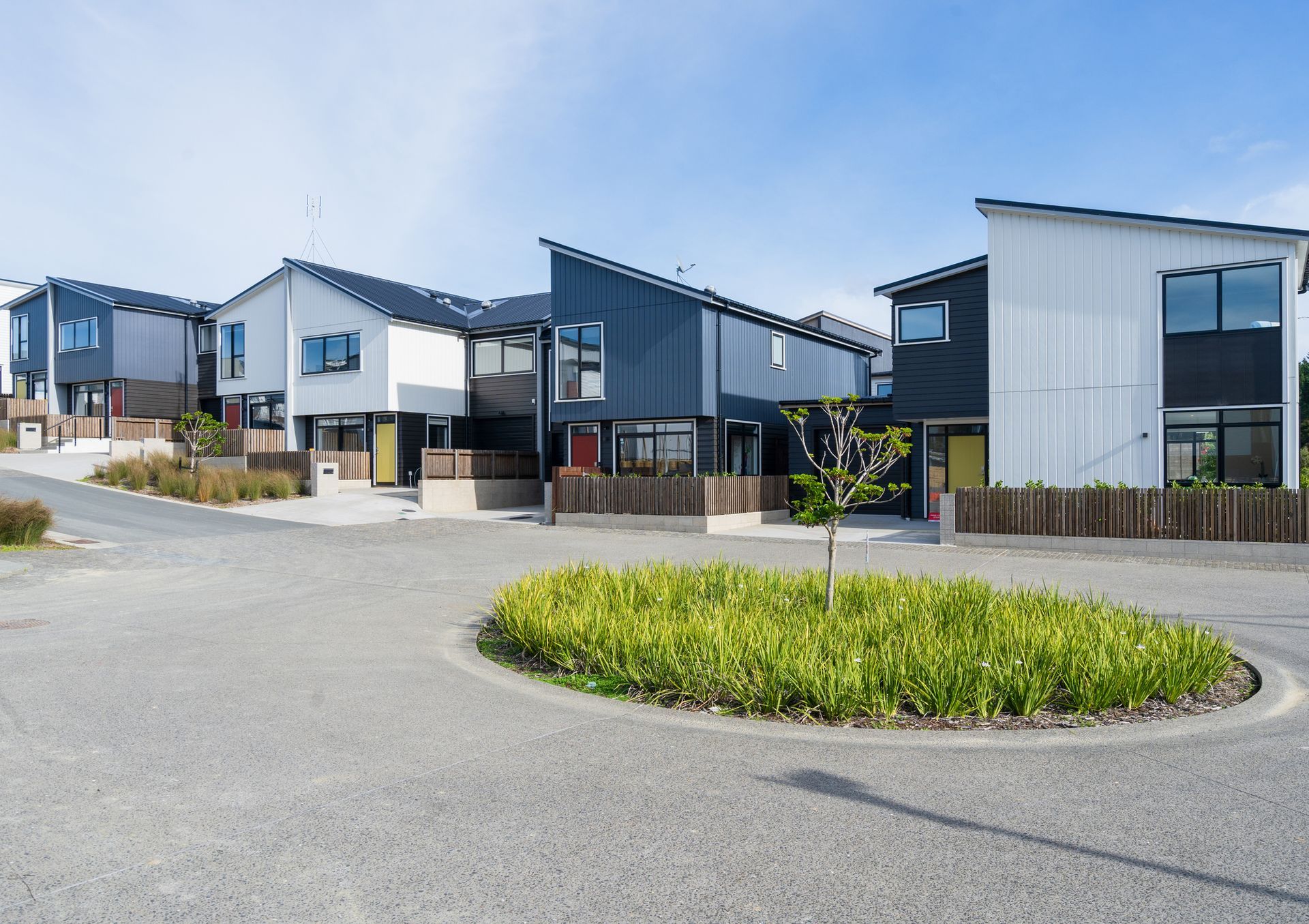 A small white house with a blue door and porch.