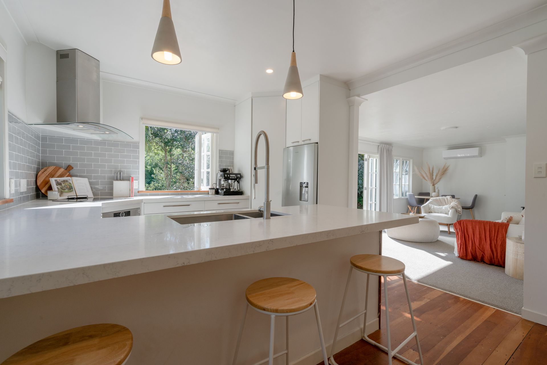 A small white house with a blue door and porch.
