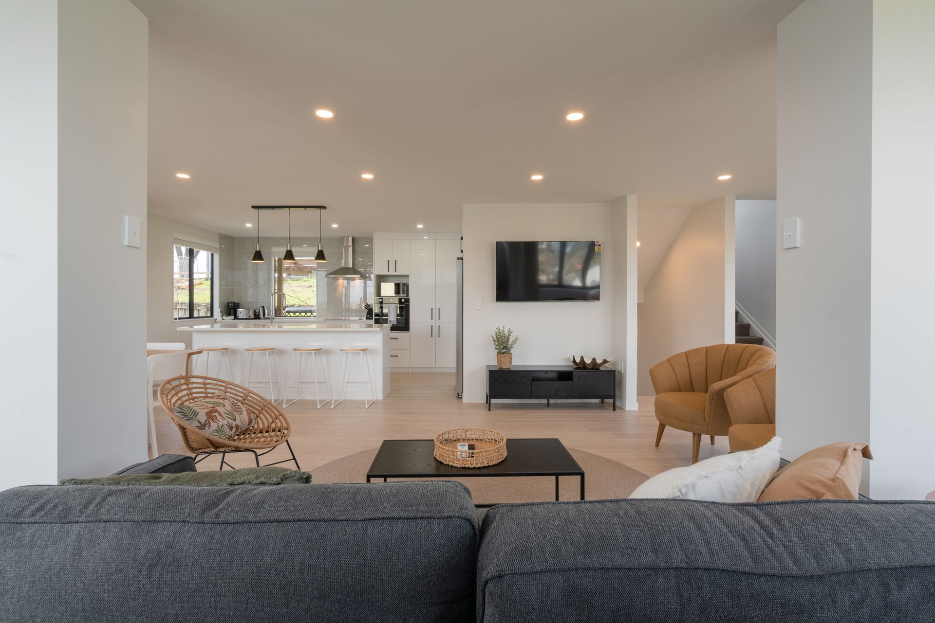 A small red and white house in the middle of a field.