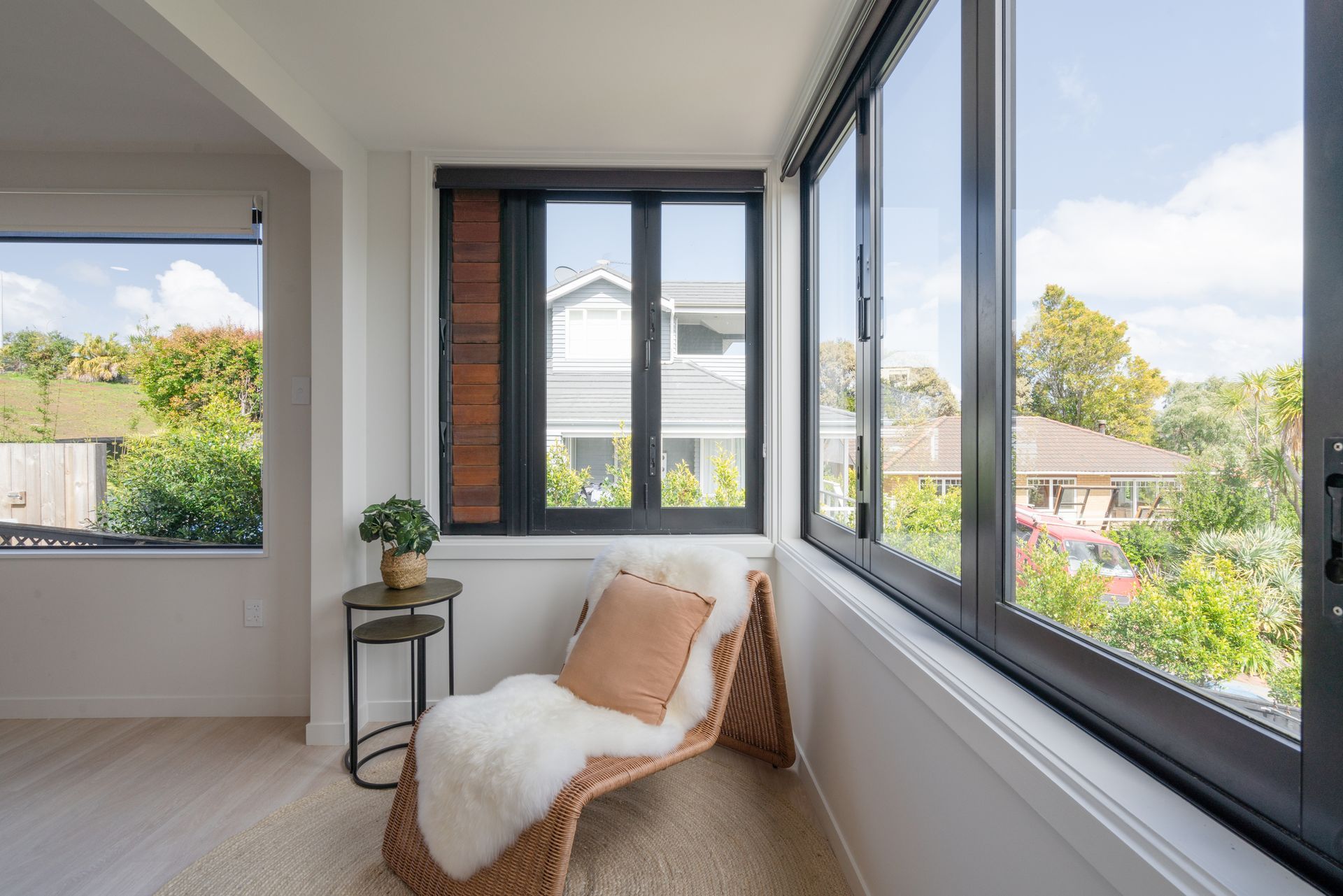 Three windows on the side of a house.