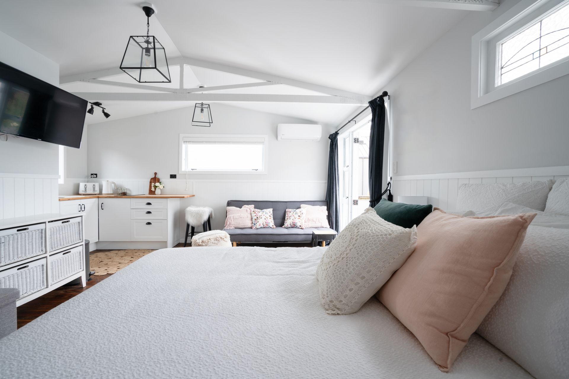 A small white house with a blue door and porch.