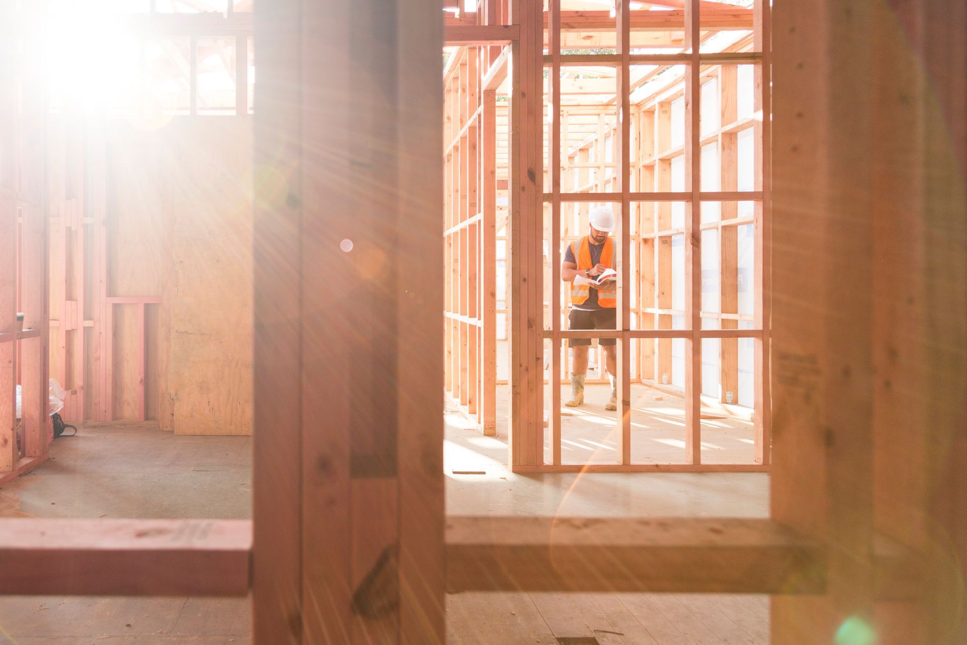 A small red and white house in the middle of a field.