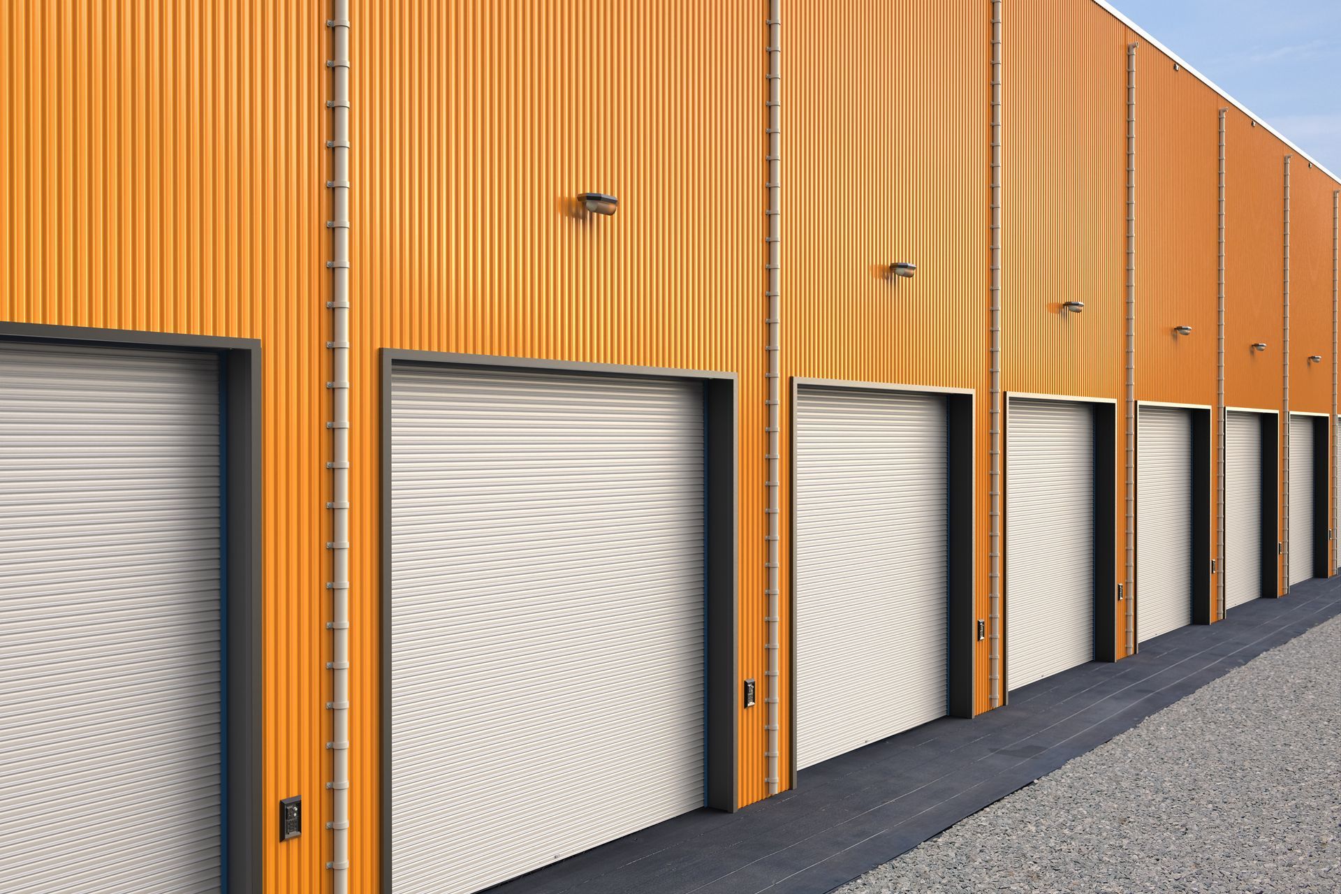 A row of orange garage doors on a building