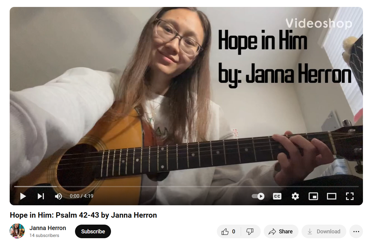 A woman is playing a guitar in a video titled hope in him