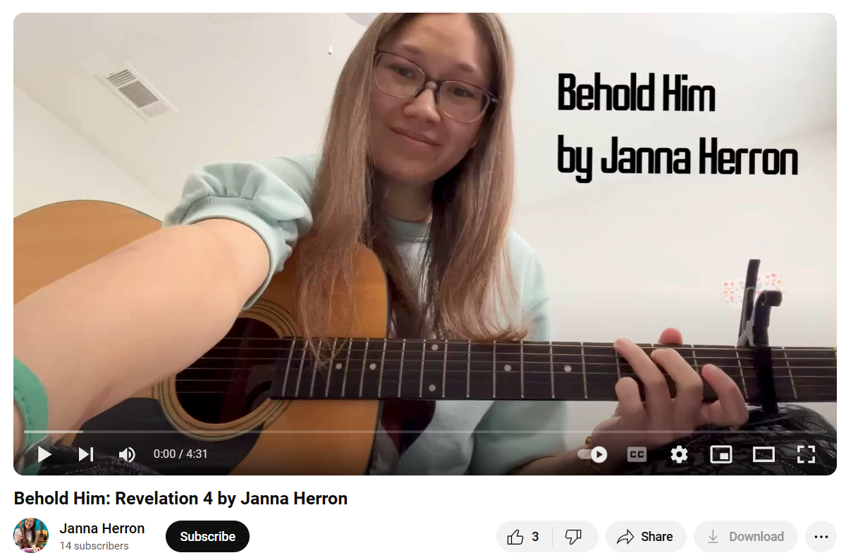 A girl is playing a guitar in a video that says behold him by janna herron