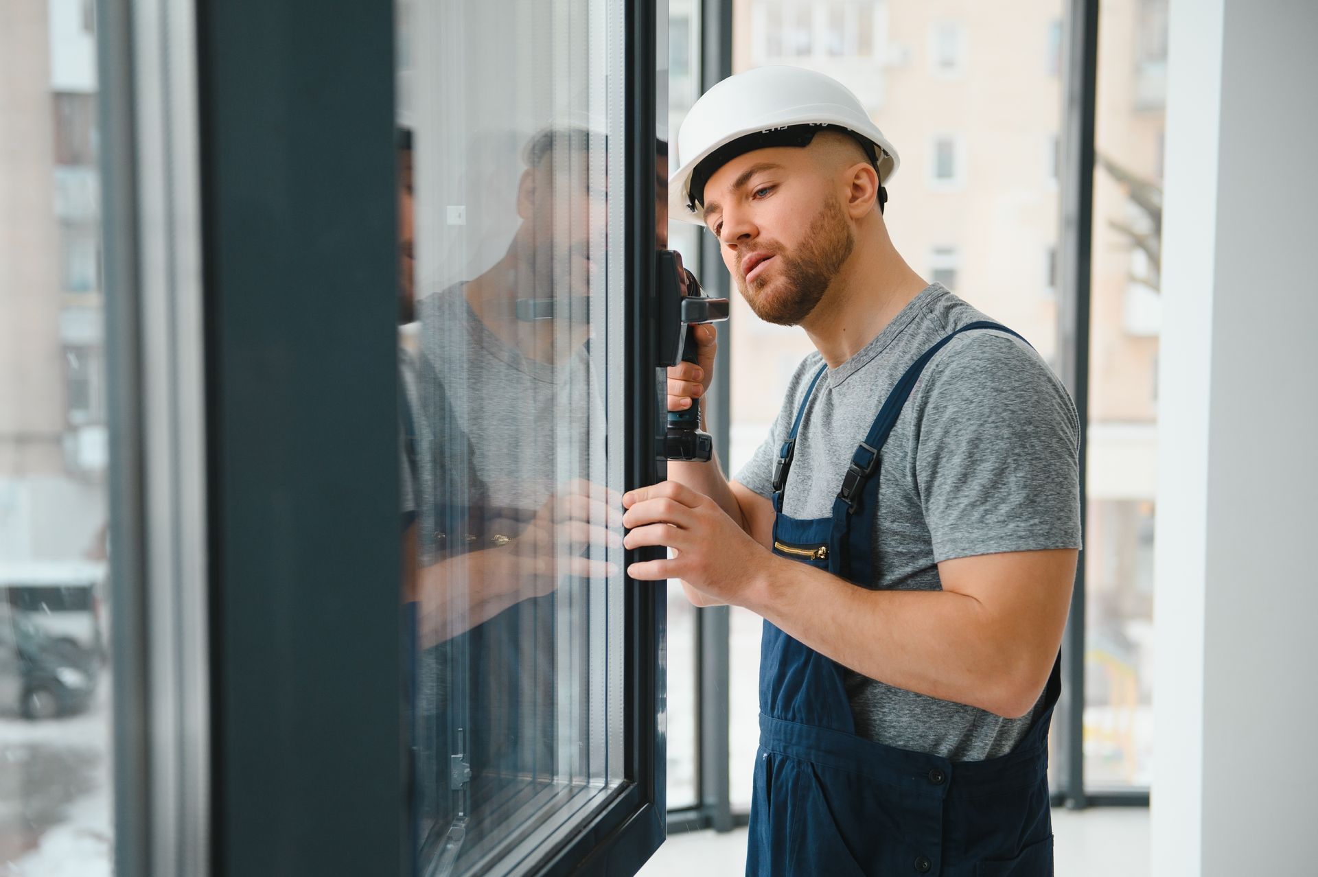 A man is installing a window in a building.