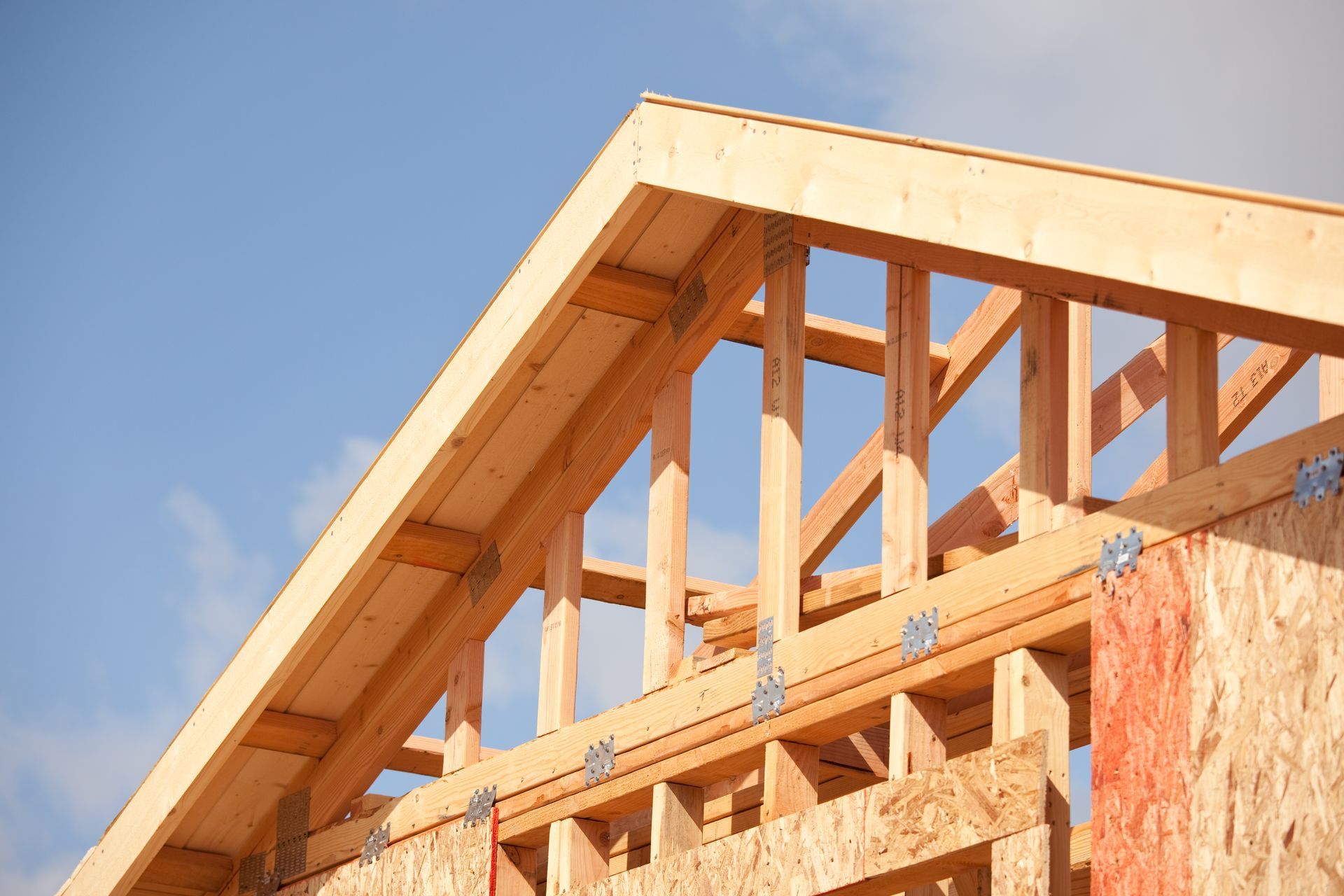 The roof of a house is being built with wooden beams.