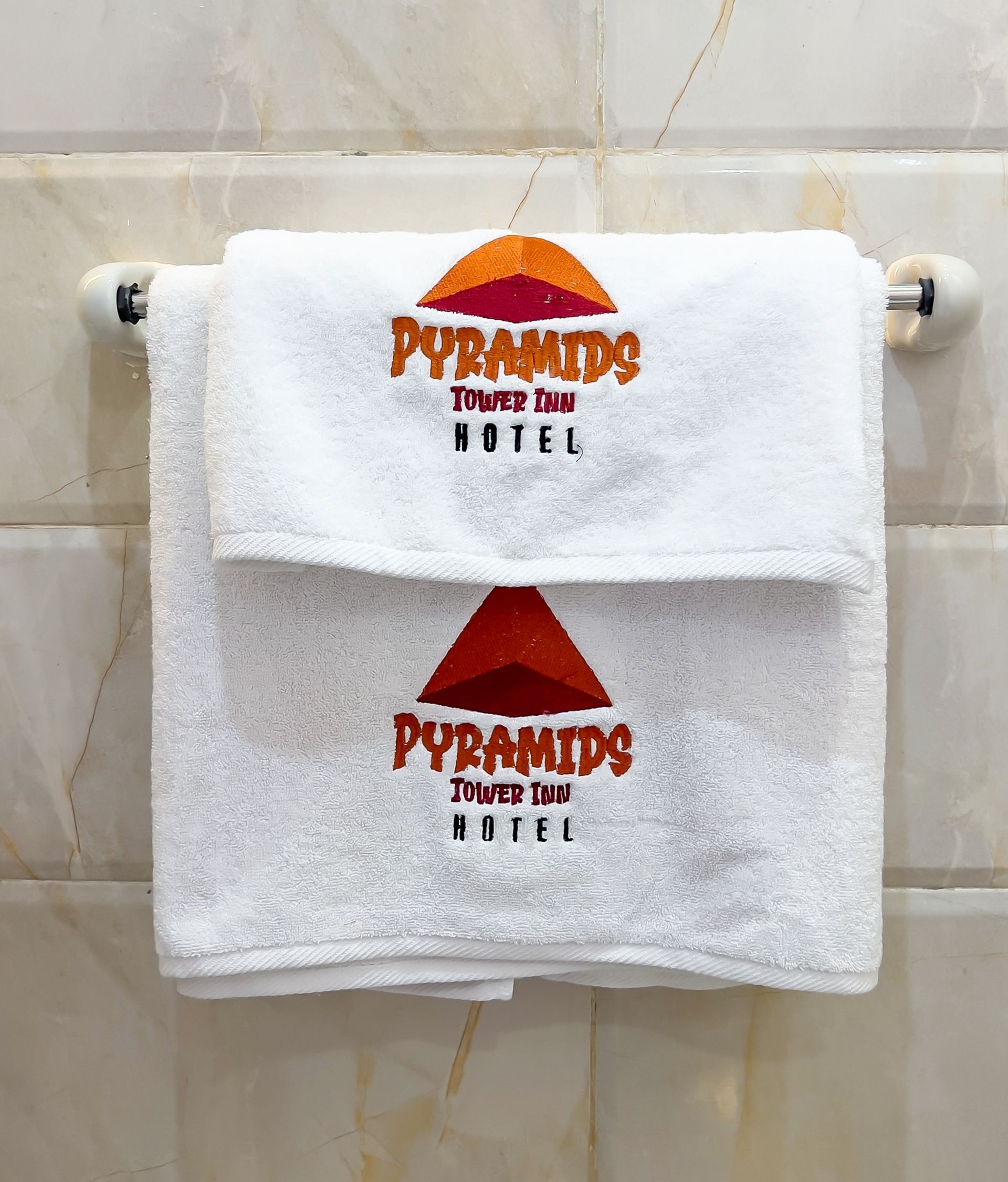 Two white towels with embroidered logo for 