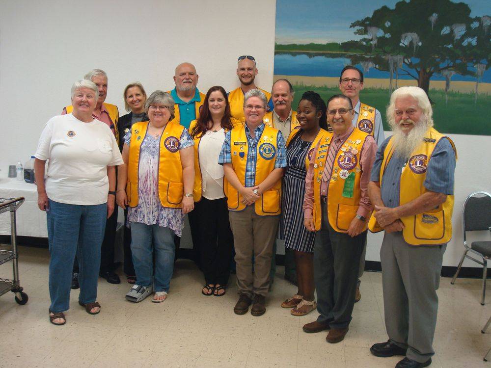 A group of people wearing yellow vests with lions on them