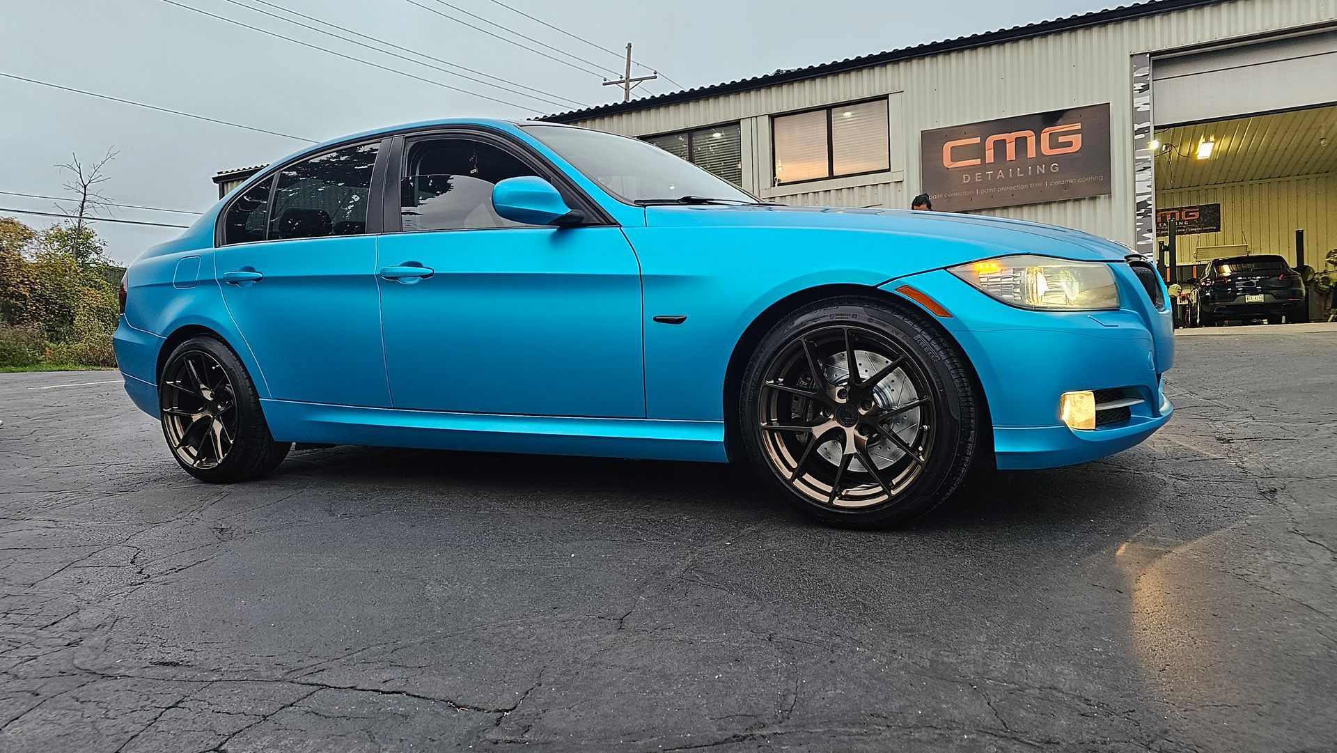Blue car parked outside a building with