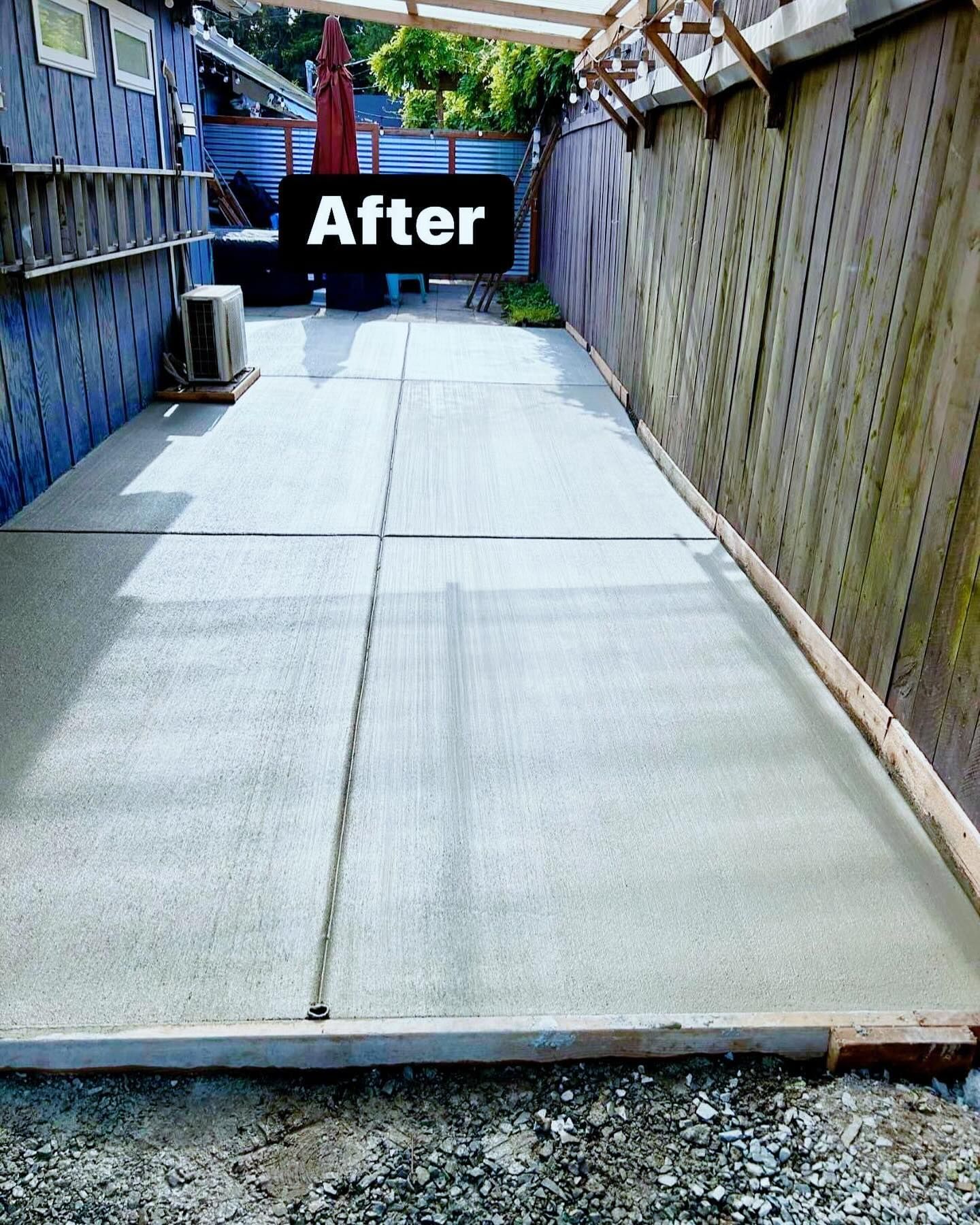 A concrete walkway with stairs leading up to a deck. | Everett, WA | JMS Concrete & Construction LLC