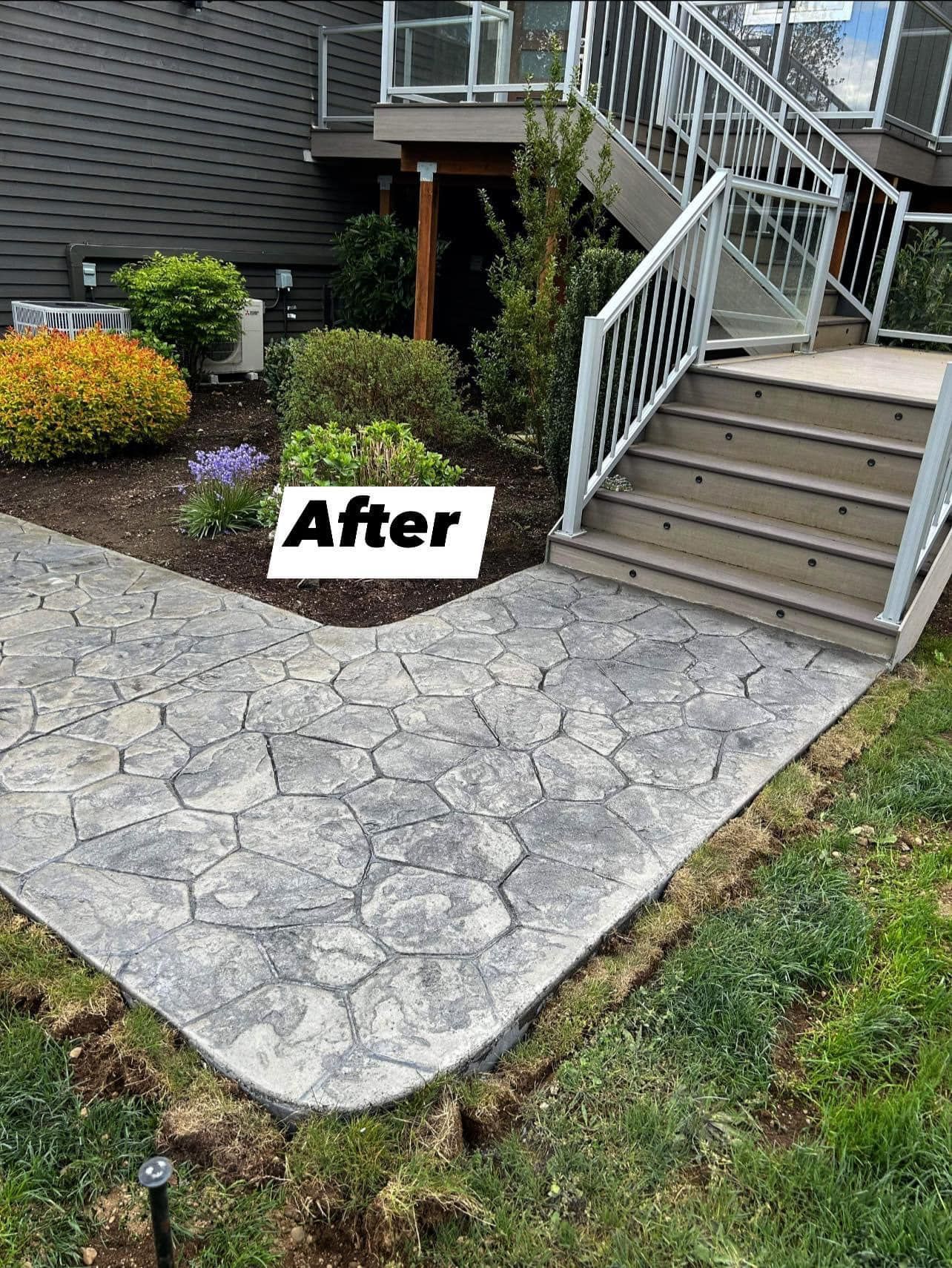 A concrete walkway with stairs leading up to a deck. | Everett, WA | JMS Concrete & Construction LLC