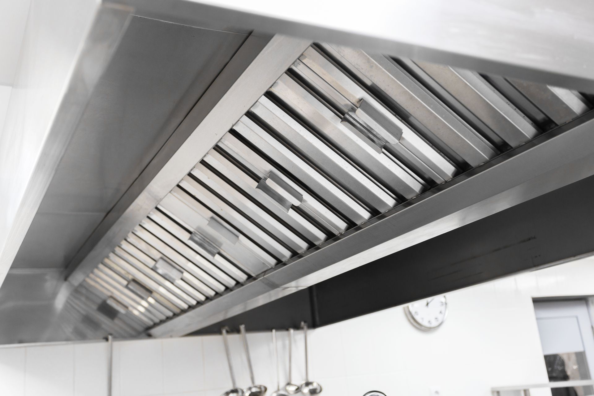 Stainless steel commercial kitchen exhaust hood.