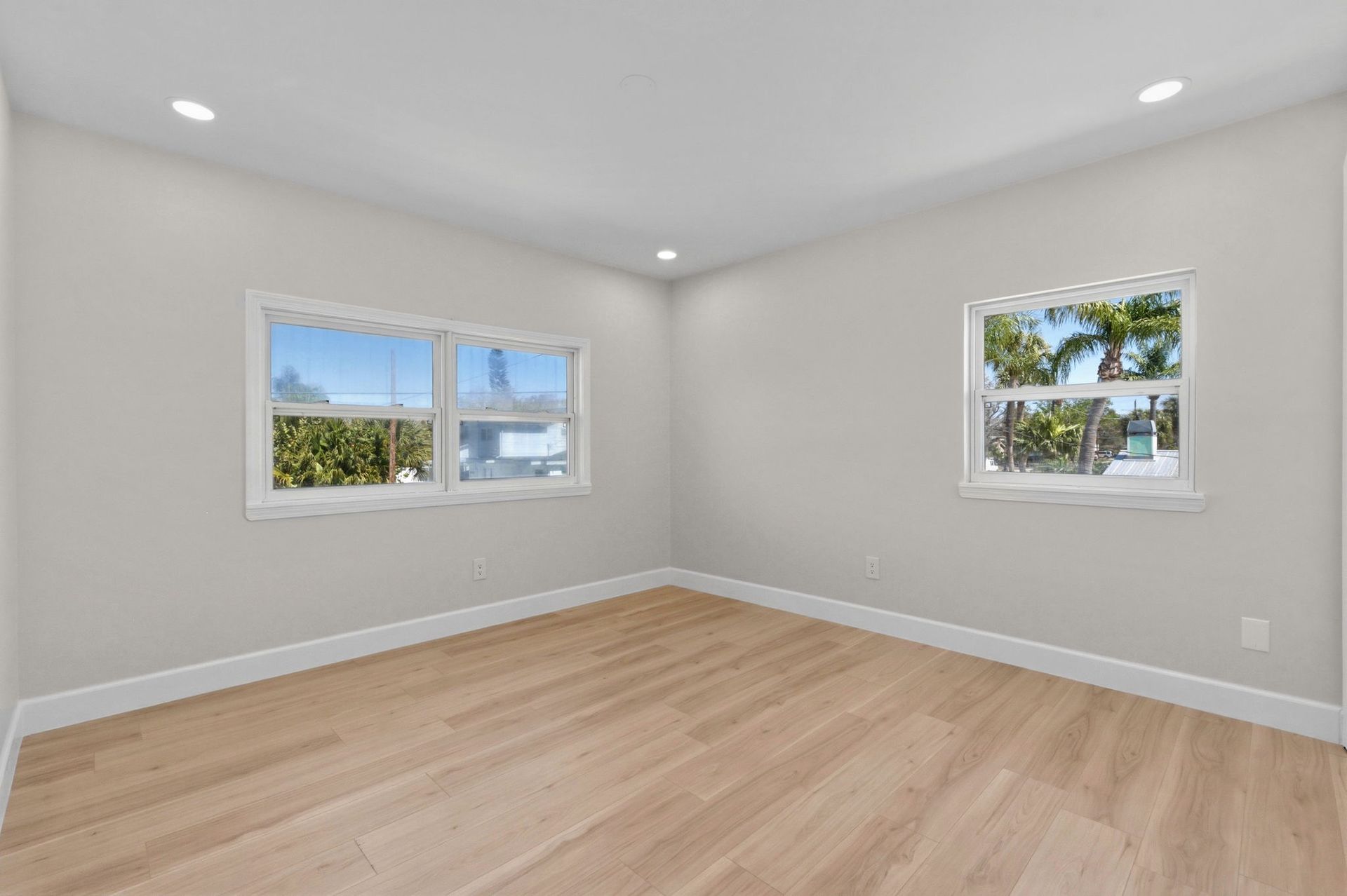 Carpenter sketches design on paper surrounded by tools on a wooden workbench.